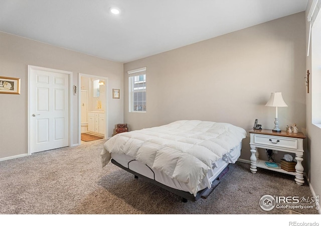 carpeted bedroom with ensuite bath