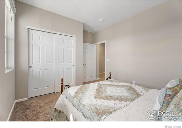 bedroom with a closet and light carpet