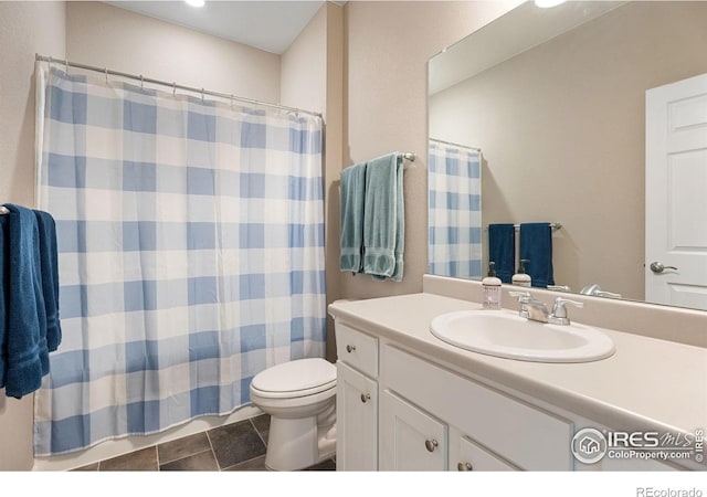 bathroom featuring walk in shower, vanity, and toilet