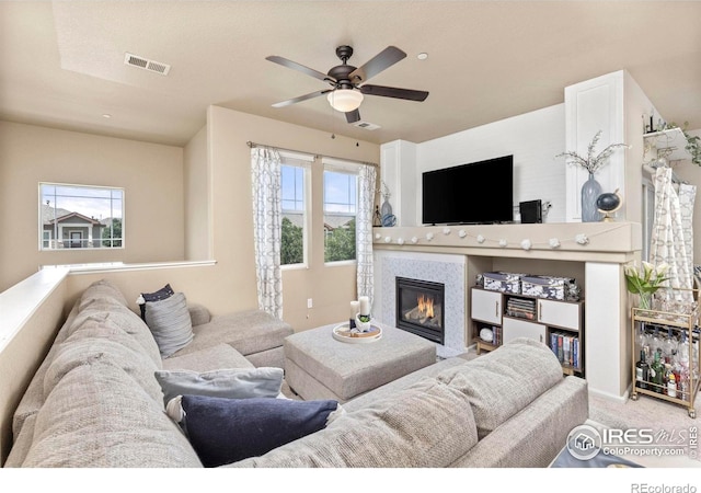 carpeted living room with ceiling fan and plenty of natural light