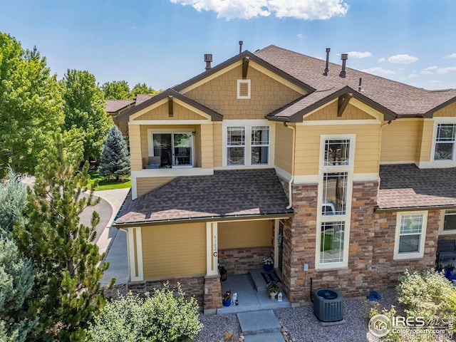 rear view of property featuring a patio area and central AC