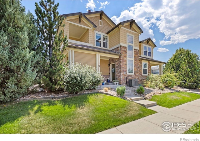 craftsman inspired home with a porch, cooling unit, and a front lawn