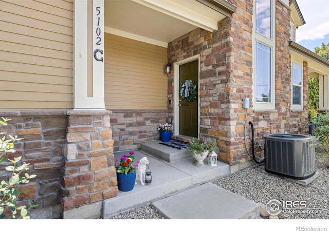 entrance to property featuring cooling unit