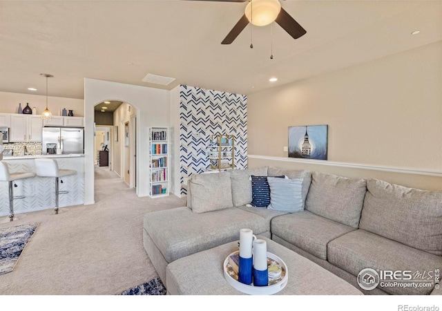 living room with ceiling fan and light carpet