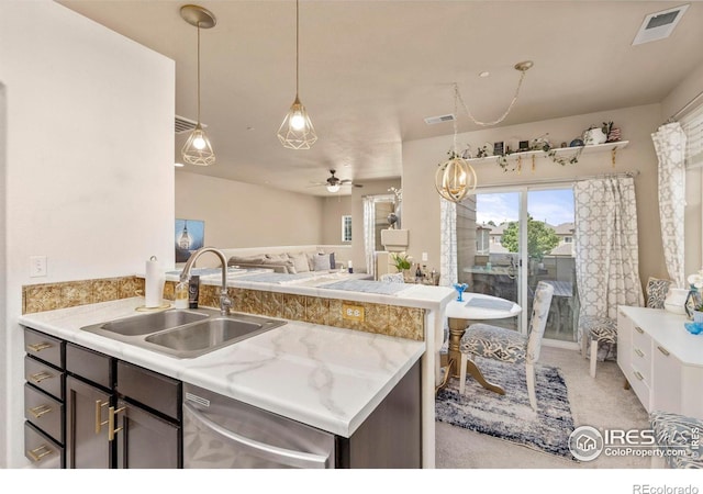 kitchen with dishwasher, ceiling fan, light stone counters, dark brown cabinetry, and sink