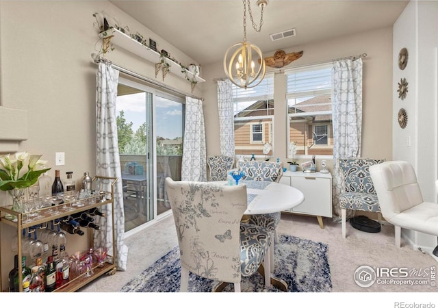 dining space featuring carpet floors and a chandelier