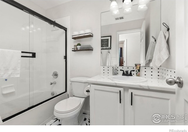 full bathroom featuring enclosed tub / shower combo, vanity, decorative backsplash, and toilet