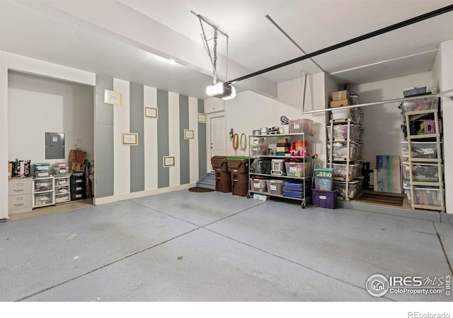 garage featuring electric panel and a garage door opener