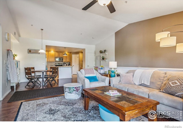 living room with ceiling fan, lofted ceiling, and dark hardwood / wood-style floors