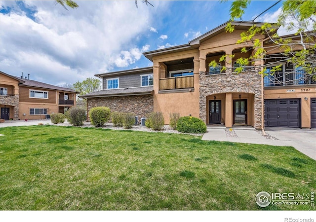 view of front of house featuring a balcony, a front lawn, and a garage