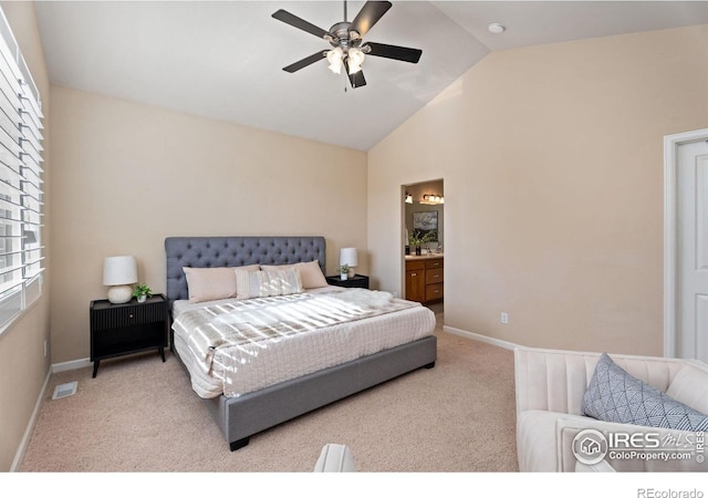 bedroom featuring ensuite bath, light carpet, ceiling fan, and multiple windows