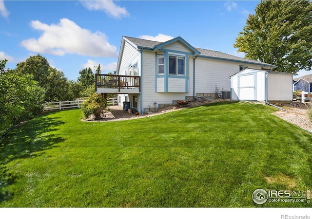 back of property featuring a wooden deck, central AC, a lawn, and a storage shed