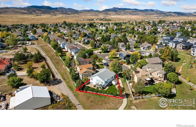 birds eye view of property featuring a mountain view