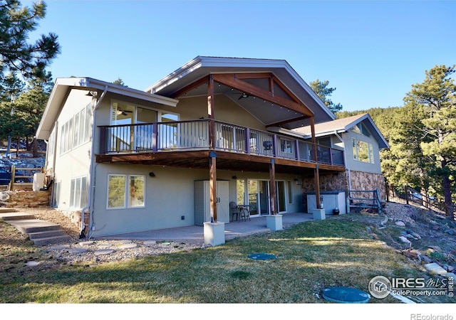 rear view of property featuring a yard and a patio area