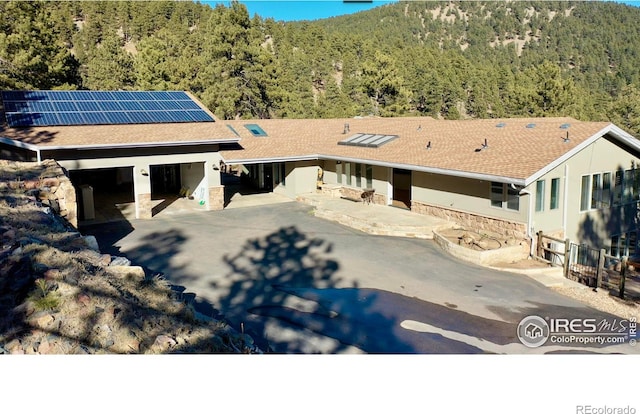 view of front facade with solar panels