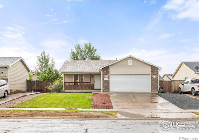 single story home featuring covered porch, a front yard, and a garage