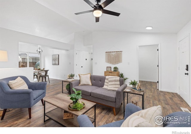 living room with lofted ceiling, ceiling fan, and dark wood-type flooring