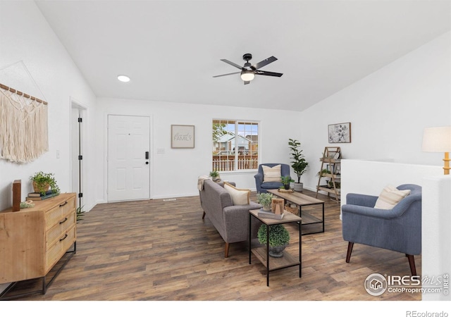 living room with ceiling fan, dark wood-type flooring, and lofted ceiling