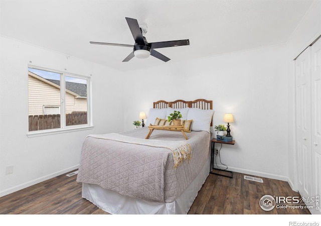 bedroom with dark wood-type flooring, a closet, and ceiling fan