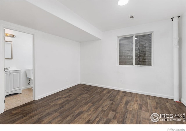 empty room with dark wood-type flooring