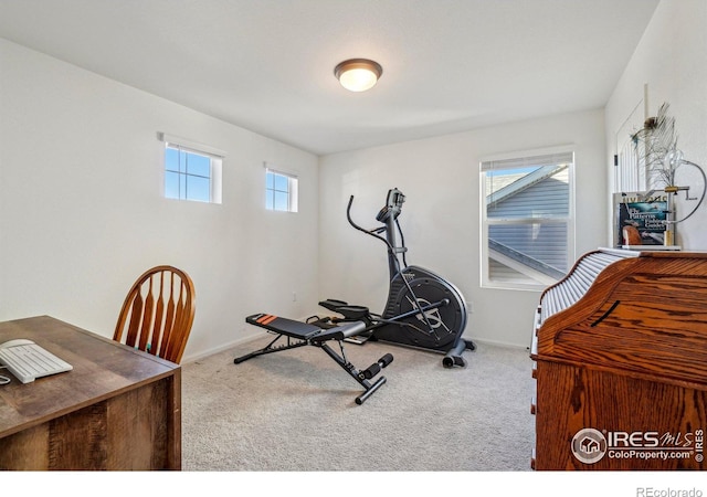 exercise room with carpet flooring and baseboards