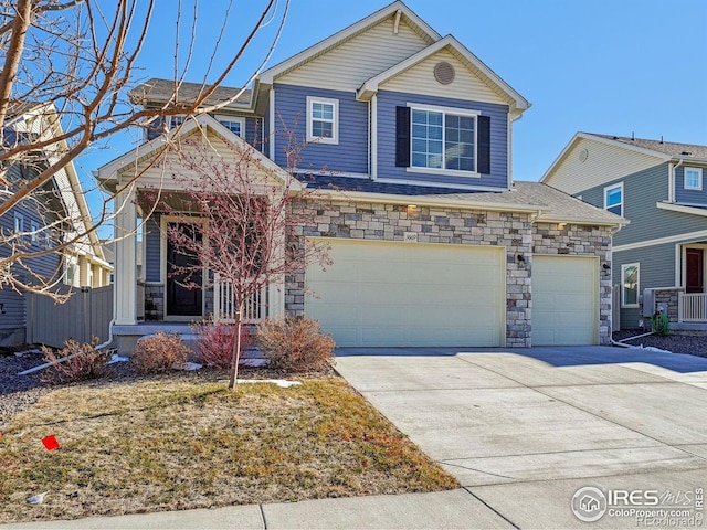 view of front of home featuring an attached garage, concrete driveway, and stone siding