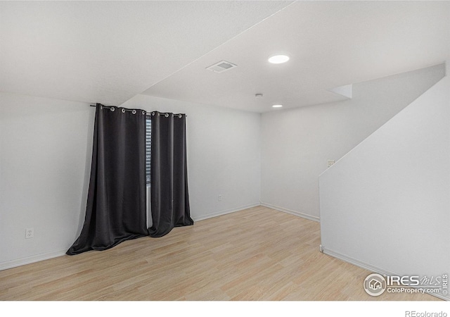 unfurnished room with light wood-type flooring