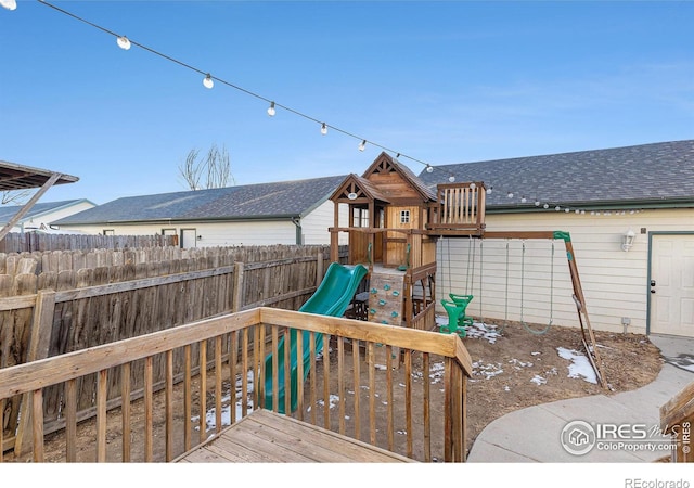 view of playground featuring a wooden deck