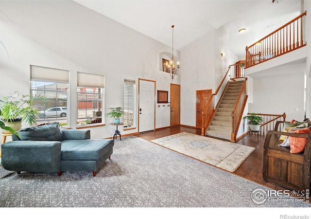 entrance foyer with a high ceiling, dark wood-type flooring, and a chandelier