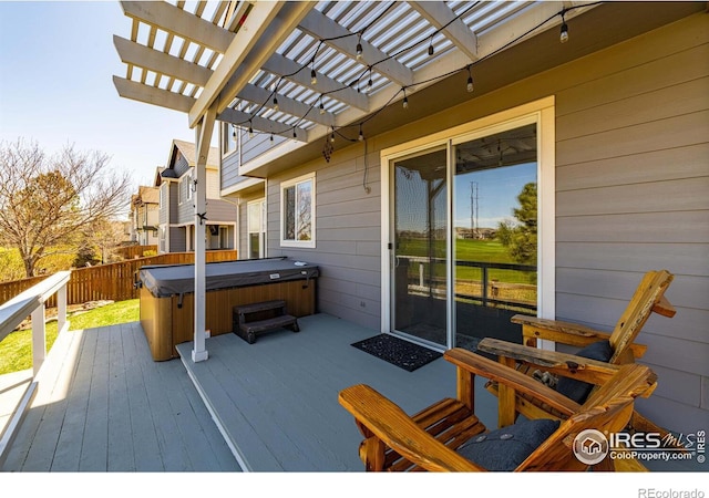 wooden deck featuring a pergola and a hot tub