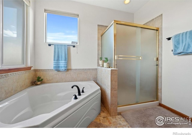 bathroom with separate shower and tub