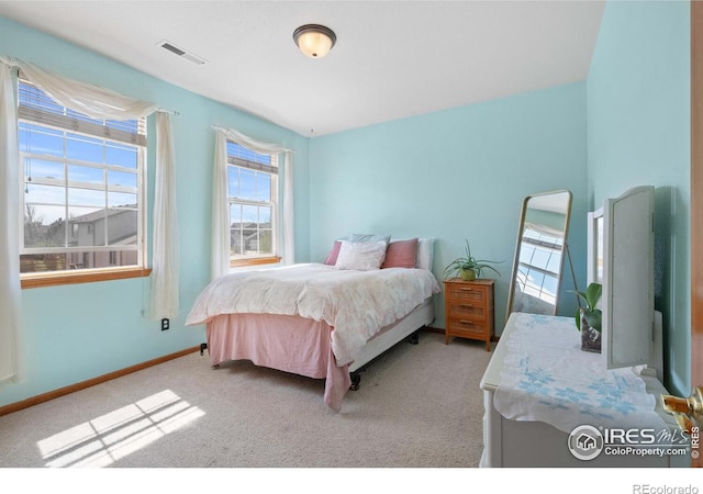 bedroom featuring light carpet