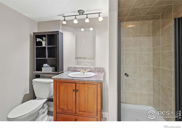 bathroom featuring vanity, toilet, and walk in shower