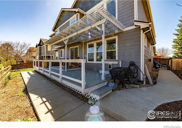 view of side of home with a pergola