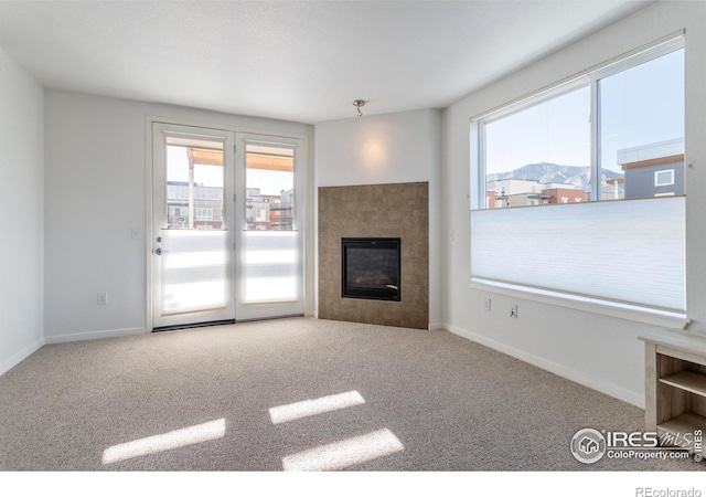 unfurnished living room with carpet floors and a mountain view