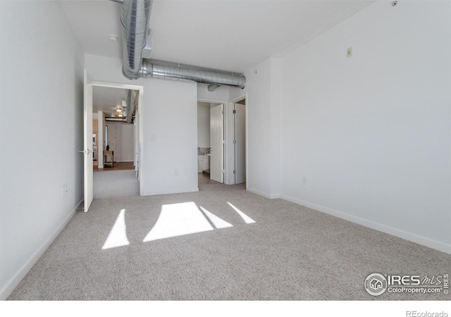 unfurnished bedroom with light colored carpet and ensuite bath