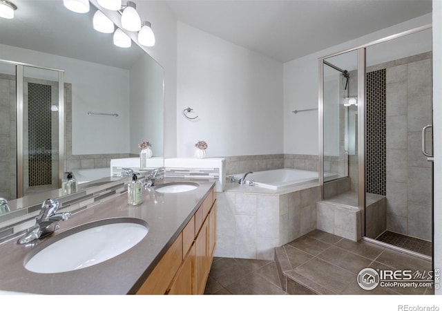 bathroom with tile patterned floors, vanity, and plus walk in shower