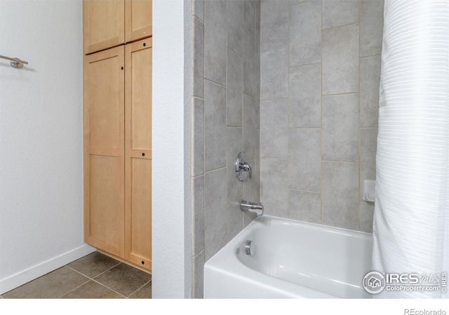 bathroom with tile patterned flooring and bathing tub / shower combination