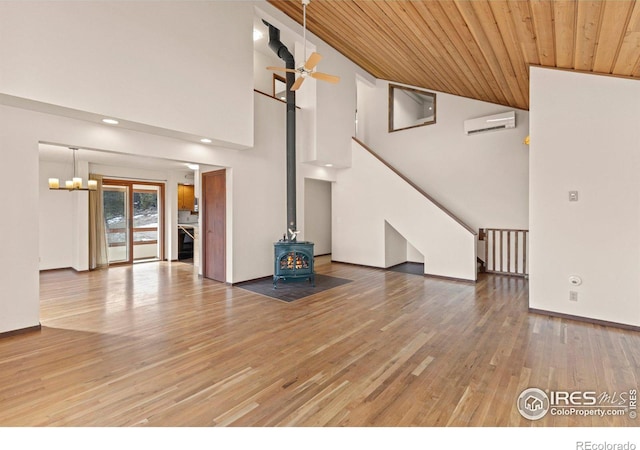 unfurnished living room featuring an AC wall unit, wood ceiling, a wood stove, high vaulted ceiling, and radiator heating unit