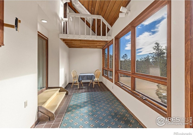 sunroom featuring wooden ceiling and lofted ceiling