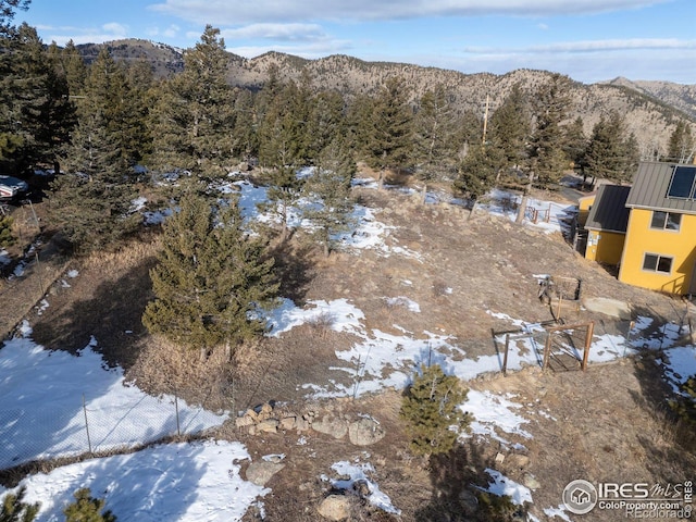 snowy aerial view featuring a mountain view