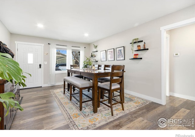 dining space with dark wood-type flooring