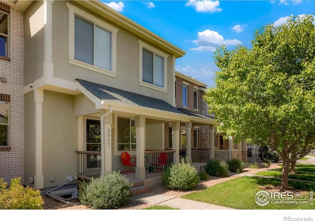 townhome / multi-family property with covered porch