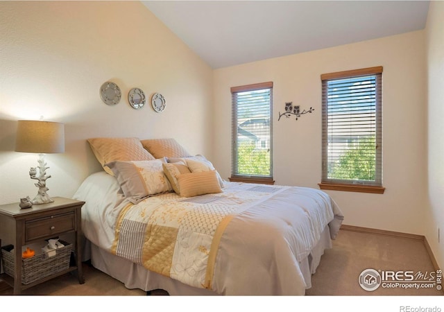 carpeted bedroom with vaulted ceiling