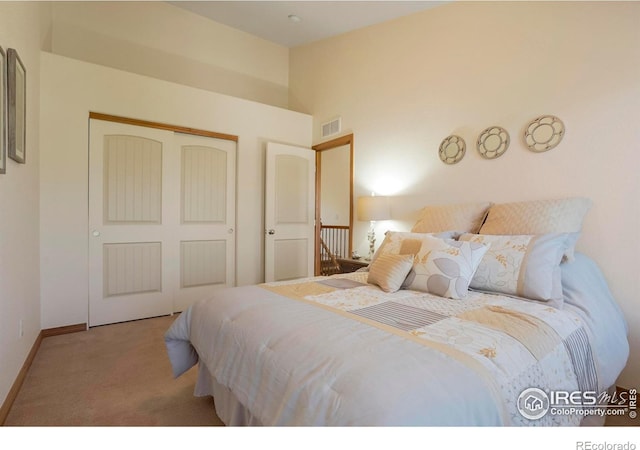 bedroom with a closet and light colored carpet