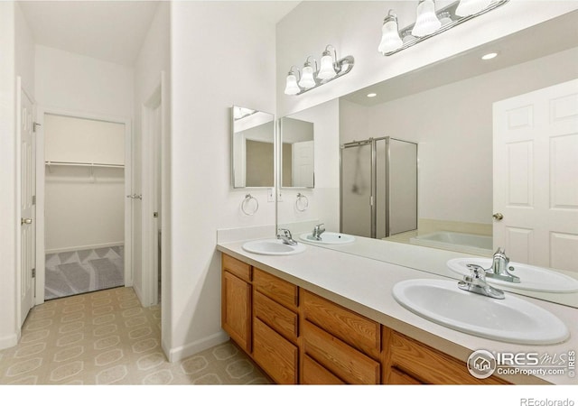 bathroom with vanity and shower with separate bathtub