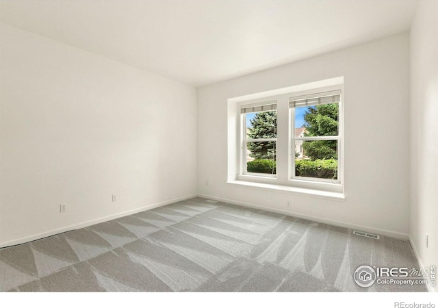 unfurnished room with light carpet