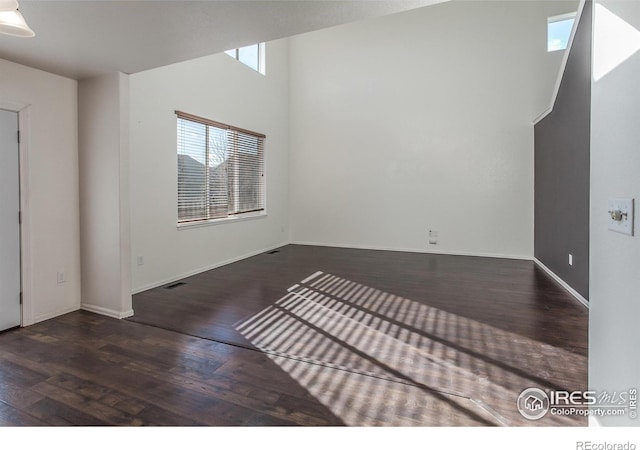 unfurnished room with dark hardwood / wood-style floors