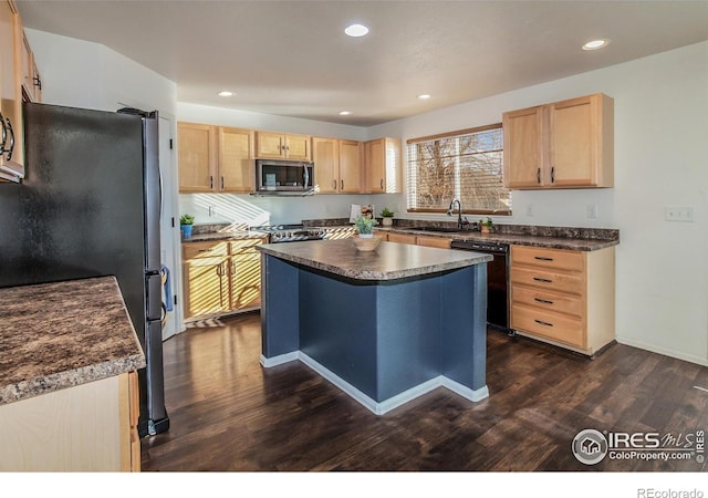 kitchen with stainless steel appliances, a center island, dark hardwood / wood-style flooring, light brown cabinetry, and sink