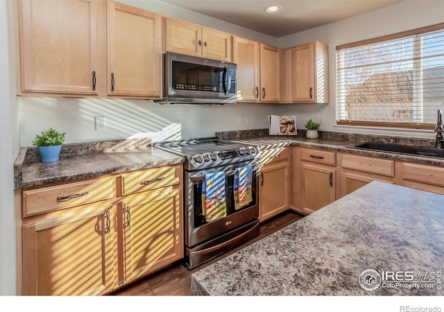 kitchen featuring light brown cabinetry, sink, and appliances with stainless steel finishes